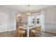 Bright dining room features a modern gold chandelier, wood floors, and seating for six at 224 Warner Crossing Way, Loris, SC 29569
