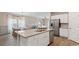 Spacious kitchen with a central island, stainless appliances, and seamless flow into the dining area at 224 Warner Crossing Way, Loris, SC 29569