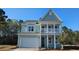 Charming two-story home features a covered porch, attached garage, and professionally landscaped yard at 305 Glacier Way, Conway, SC 29526