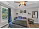 Cozy bedroom with tray ceiling, ceiling fan, and a large window at 3096 Hugo Rd., Conway, SC 29527