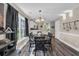 Cozy dining area with hardwood floors, stylish lighting and a view into the adjacent kitchen space at 3096 Hugo Rd., Conway, SC 29527