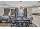 Inviting dining room area featuring hardwood floors, modern lighting, and backyard views at 3096 Hugo Rd., Conway, SC 29527