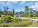 Single story home with an expansive lawn and ample parking, set against a backdrop of mature trees at 3096 Hugo Rd., Conway, SC 29527