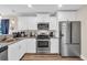 Bright kitchen with white cabinets, stainless steel appliances, and granite countertops at 3096 Hugo Rd., Conway, SC 29527