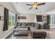 Comfortable living room featuring hardwood floors, a large sectional sofa and large windows for natural light at 3096 Hugo Rd., Conway, SC 29527