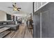 Open-concept living room with vaulted ceilings, wood floors and a view into the dining and kitchen areas at 3096 Hugo Rd., Conway, SC 29527