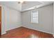 This bedroom features wood flooring, a tray ceiling, and a window at 319 Sparrow Dr., Surfside Beach, SC 29575