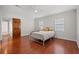 The bedroom boasts wood floors, natural light, and a ceiling fan at 319 Sparrow Dr., Surfside Beach, SC 29575