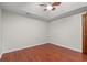 A clean bedroom featuring a ceiling fan and dark, faux-wood flooring at 319 Sparrow Dr., Surfside Beach, SC 29575