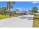 Charming home with a long driveway, garage, a metal roof and palm trees at 319 Sparrow Dr., Surfside Beach, SC 29575
