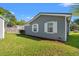 Home exterior featuring gray siding, white trim, green grass, and a garden bed at 319 Sparrow Dr., Surfside Beach, SC 29575