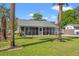 Inviting home with a screened porch, lovely landscaping, and an American flag waving proudly at 319 Sparrow Dr., Surfside Beach, SC 29575