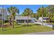 Charming single-story home featuring a metal roof, palm trees, and a well-maintained lawn at 319 Sparrow Dr., Surfside Beach, SC 29575