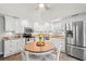 Bright kitchen with stainless steel appliances, ample cabinets, and a round wooden breakfast table at 319 Sparrow Dr., Surfside Beach, SC 29575