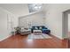 Bright living room featuring hardwood floors, comfortable seating, and a skylight for natural light at 319 Sparrow Dr., Surfside Beach, SC 29575