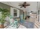 Cozy screened-in porch with rocking chairs and ceiling fans creating a relaxing outdoor space at 319 Sparrow Dr., Surfside Beach, SC 29575