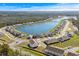Wide aerial view showcasing a residential community situated by a lake surrounded by lush green trees at 3549 Bells Lake Circle, Longs, SC 29568