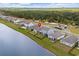 Aerial view of a home near a serene lake with a forested backdrop and community walking trails at 3549 Bells Lake Circle, Longs, SC 29568