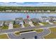 Aerial view of home with a lake view featuring a well-manicured lawn and a neighborhood mailbox at 3549 Bells Lake Circle, Longs, SC 29568