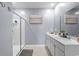 Bathroom featuring double sinks, a framed painting, a mirror, and a walk-in shower with glass doors at 3549 Bells Lake Circle, Longs, SC 29568