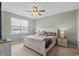 A charming bedroom showcasing a comfortable bed, a ceiling fan, and a picturesque window view at 3549 Bells Lake Circle, Longs, SC 29568