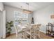 Bright dining area featuring lake views, pendant lighting, and stylish white wooden table with chairs at 3549 Bells Lake Circle, Longs, SC 29568