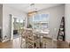 Dining area with table seating six, view to covered patio and lake at 3549 Bells Lake Circle, Longs, SC 29568