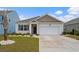 Inviting single-Gathering home featuring a manicured lawn, a two-car garage, and a welcoming front entrance at 3549 Bells Lake Circle, Longs, SC 29568