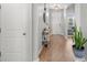 A home's foyer with hardwood floors, a white door, and a plant at 3549 Bells Lake Circle, Longs, SC 29568