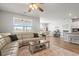 Inviting living room showcases lake views through large windows, featuring comfortable seating and stylish decor at 3549 Bells Lake Circle, Longs, SC 29568