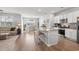Open-concept living space with white cabinets, island seating, a dining area, and a cozy living room at 3549 Bells Lake Circle, Longs, SC 29568