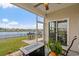 Covered patio overlooking a lake with outdoor seating and grill at 3549 Bells Lake Circle, Longs, SC 29568