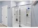 Bright bathroom featuring a clean white shower with built-in shelving and sliding glass doors at 3549 Bells Lake Circle, Longs, SC 29568