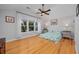 Bright bedroom with large window, ceiling fan, hardwood floors, and neutral walls at 4520 Hedrick St., North Myrtle Beach, SC 29582