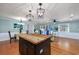 Open-concept living room with a kitchen island, dining area, and lots of natural light at 4520 Hedrick St., North Myrtle Beach, SC 29582