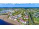 Panoramic aerial view showcasing waterfront condos, a marina, golf course, and a town beyond at 4560 Greenbriar Dr. # 306B, Little River, SC 29566