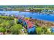 Aerial view showcasing waterfront condos with private docks, a lush landscape, and waterway access at 4560 Greenbriar Dr. # 306B, Little River, SC 29566