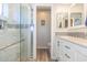 Bathroom featuring glass enclosed shower and double vanity with granite countertops at 4560 Greenbriar Dr. # 306B, Little River, SC 29566