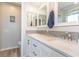 Bathroom featuring double vanity with white cabinets and a framed mirror at 4560 Greenbriar Dr. # 306B, Little River, SC 29566