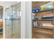 Bathroom featuring glass enclosed shower with storage space for towels and cleaning supplies at 4560 Greenbriar Dr. # 306B, Little River, SC 29566