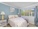 Cozy bedroom featuring a patterned accent wall, large window, and comfortable bed at 4560 Greenbriar Dr. # 306B, Little River, SC 29566