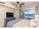 This is a bedroom with a ceiling fan and balcony overlooking the river or lake at 4560 Greenbriar Dr. # 306B, Little River, SC 29566
