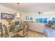 Open floor plan living room with water views, glass dining table and comfortable seating at 4560 Greenbriar Dr. # 306B, Little River, SC 29566