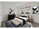 Modern bedroom featuring neutral tones, ample natural light, stylish furnishings, and curated artwork at 476 Honeyhill Loop, Conway, SC 29526