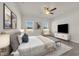 Cozy bedroom with plush bedding, neutral tones, bright windows, and modern ceiling fan at 476 Honeyhill Loop, Conway, SC 29526