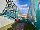 A vibrant community space with colorful murals, red Adirondack chairs, and fun games on a sunny day at 476 Honeyhill Loop, Conway, SC 29526
