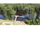 An aerial view of a wooden dock and pier surrounded by serene water and lush green trees at 476 Honeyhill Loop, Conway, SC 29526