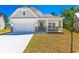 Charming single-story home with white siding, stone accents, a covered porch, and an attached garage at 476 Honeyhill Loop, Conway, SC 29526