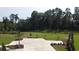 An aerial view of parking spots and landscaping near a vast green space, lined with trees and greenery at 476 Honeyhill Loop, Conway, SC 29526