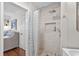 Bathroom featuring a shower with elegant tile work, recessed niche, and modern fixtures at 4999 Highway 17 Business # 302, Murrells Inlet, SC 29576